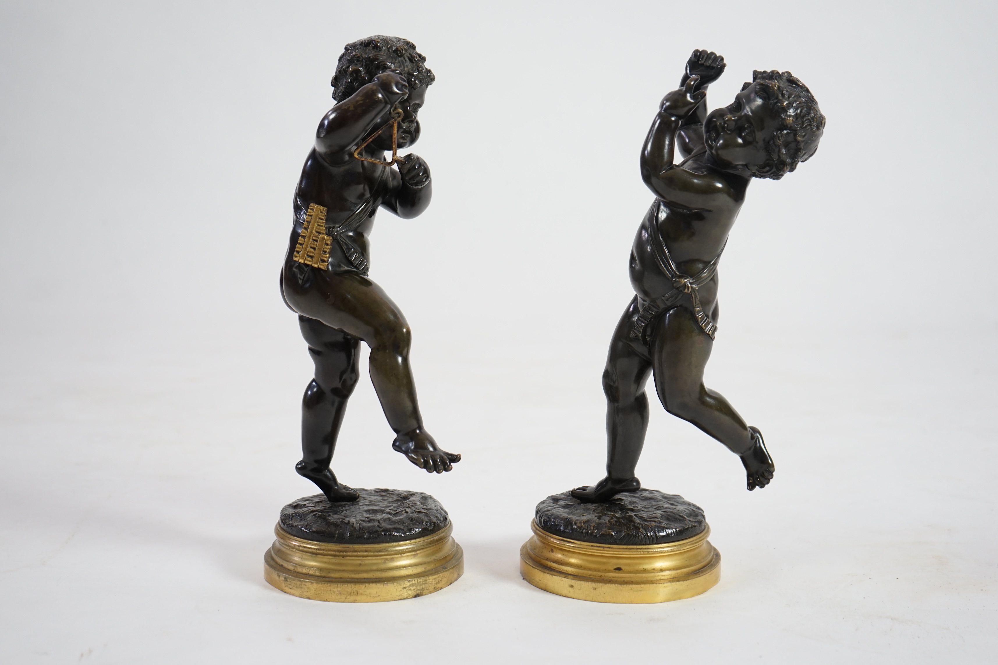 After Claude Michel Clodion (French, 1738-1814), a pair of late 19th century bronze figures of musical putti